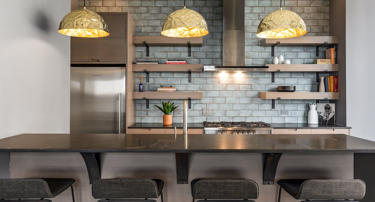 Skylounge kitchen at 330 S Wells Apartments in Chicago with pendant lights, bar seating, and open shelving