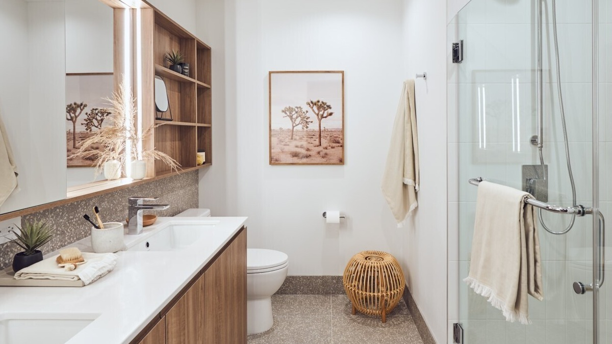Contemporary bathroom featuring a double vanity, open shelving, framed art, and a glass walk-in shower at 369 Grand apartments in Chicago
