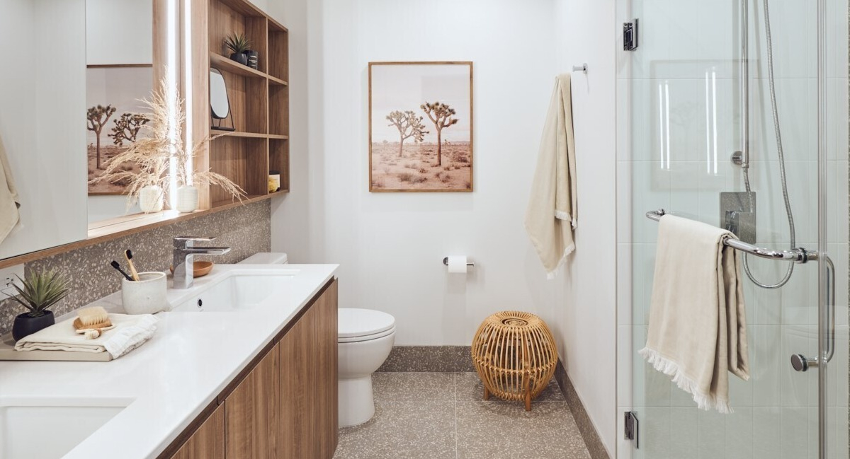 Contemporary bathroom featuring a double vanity, open shelving, framed art, and a glass walk-in shower at 369 Grand apartments in Chicago
