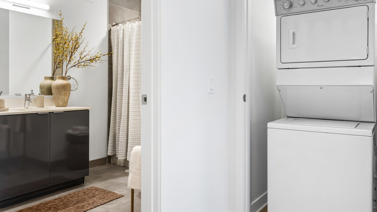 Modern bathroom with sleek vanity and in-unit washer dryer at 3Eleven Luxury Apartments in Chicago