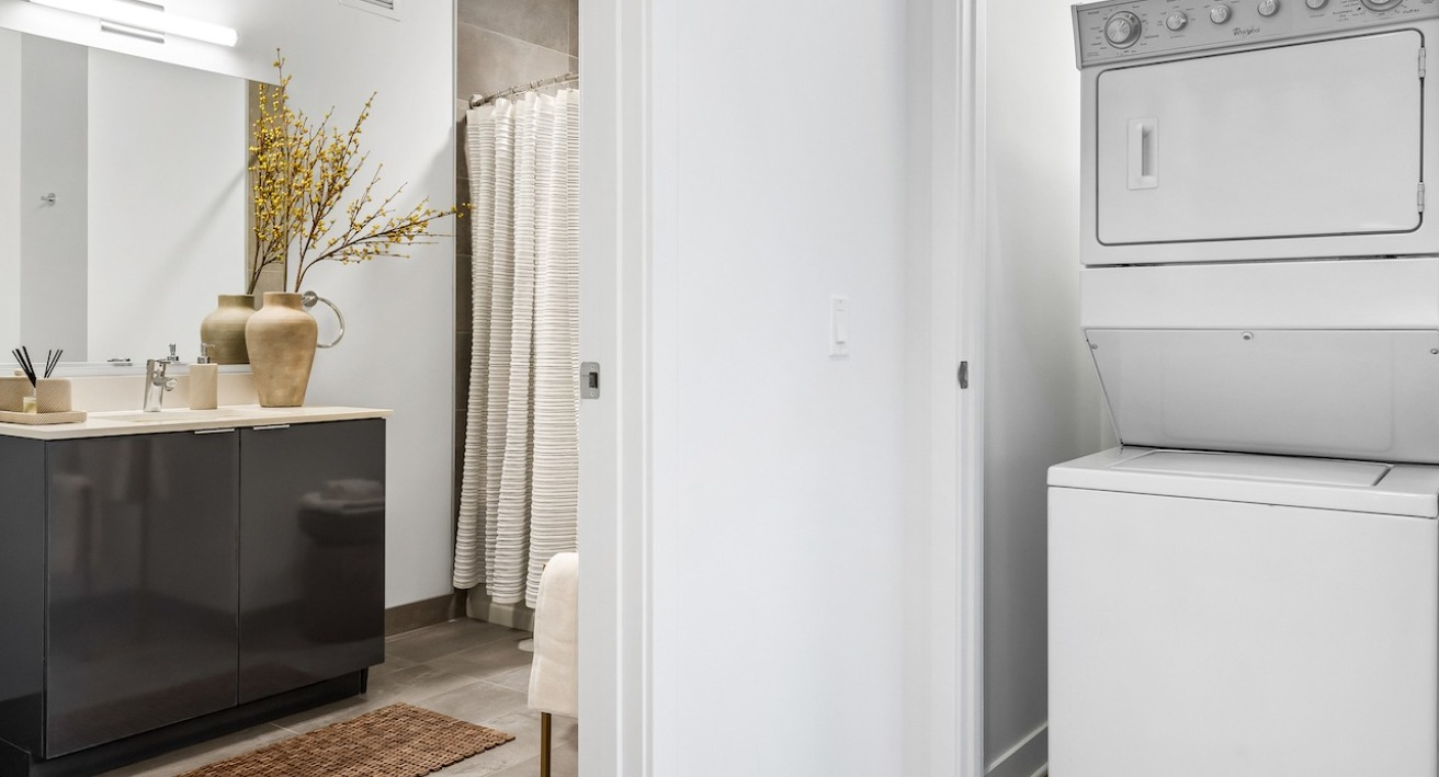 Modern bathroom with sleek vanity and in-unit washer dryer at 3Eleven Luxury Apartments in Chicago