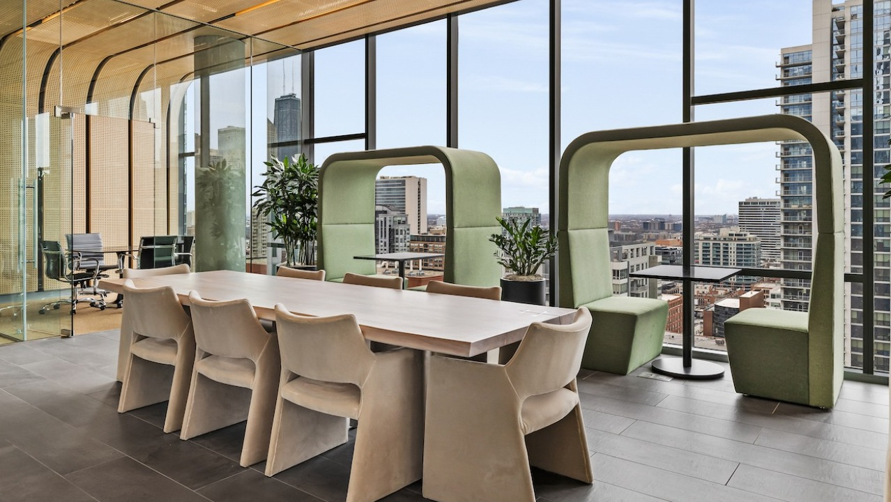 Modern meeting room with long table and lounge seating at 3Eleven Luxury Apartments in Chicago with city views