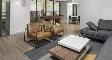 Resident lounge and game room with leather chairs, modern sofa, coffee tables, and a billiards area at 420 East Ohio apartments in Chicago, designed for socializing