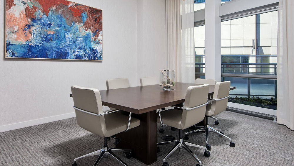 Modern conference room with large table, artwork, and natural light at 465 North Park apartments in Chicago