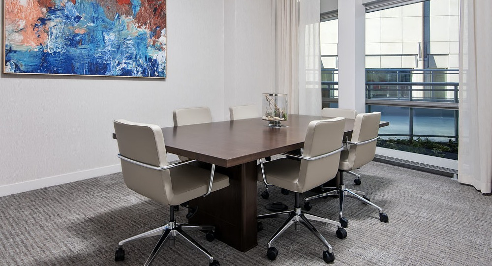 Modern conference room with large table, artwork, and natural light at 465 North Park apartments in Chicago