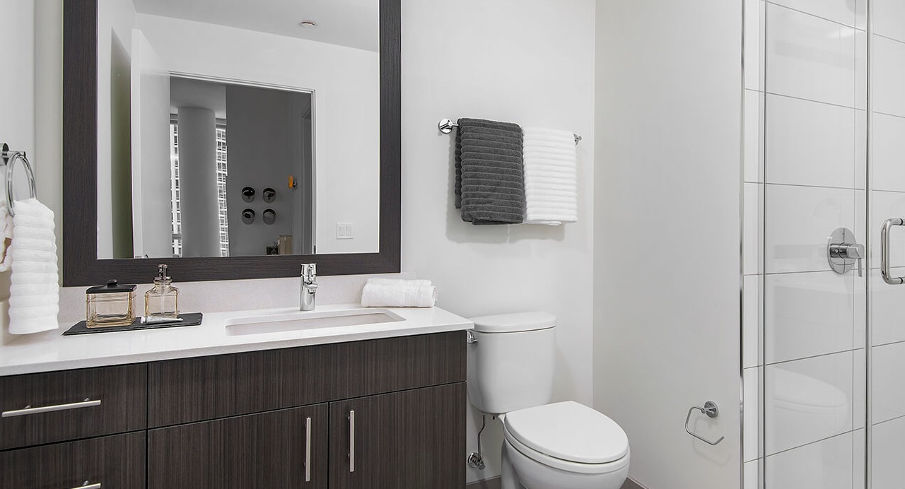 Contemporary bathroom with walk-in shower, modern vanity, and neutral design at 465 North Park apartments in Chicago