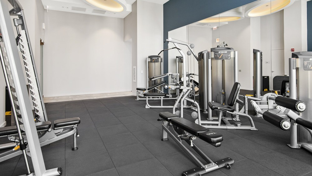 Fitness center with weight machines and strength equipment at 465 North Park apartments in Chicago
