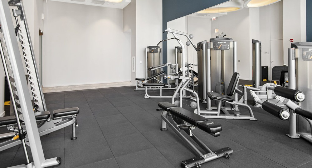 Fitness center with weight machines and strength equipment at 465 North Park apartments in Chicago