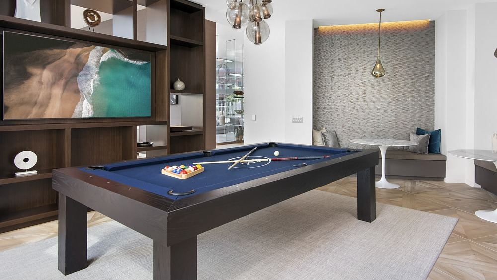 Modern game room with pool table, lounge seating, and entertainment area at 465 North Park apartments in Chicago