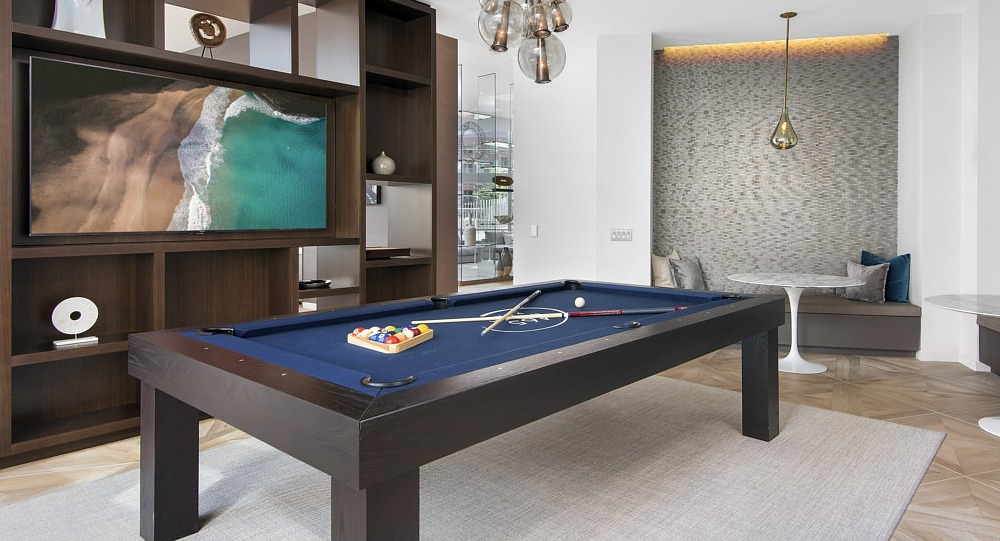 Modern game room with pool table, lounge seating, and entertainment area at 465 North Park apartments in Chicago