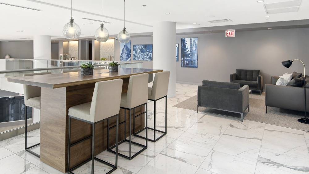 Stylish mezzanine lounge with high-top seating and modern décor at 465 North Park apartments in Chicago