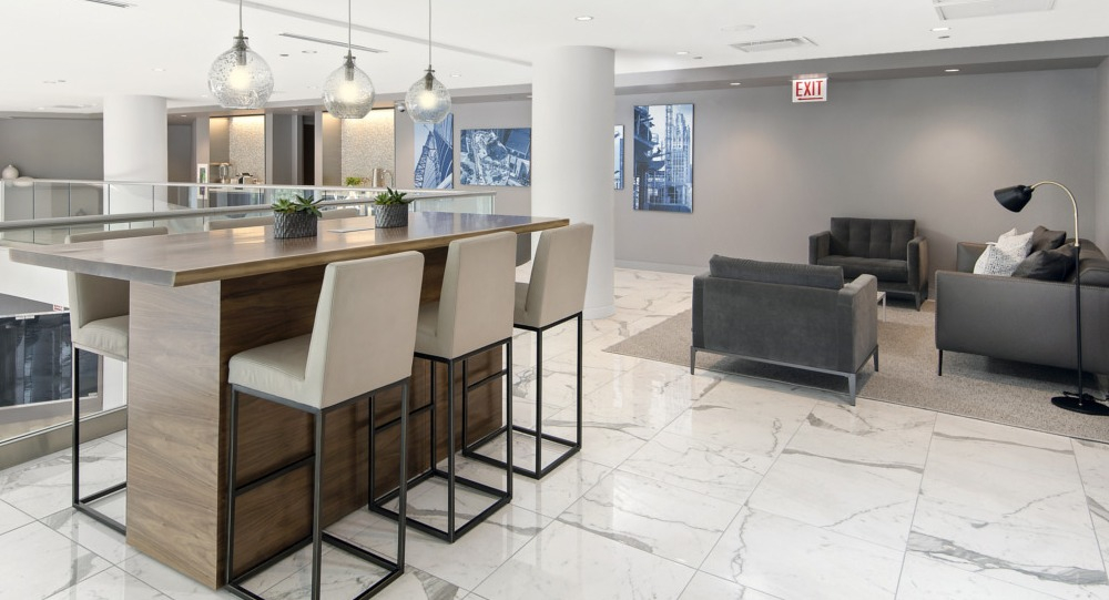 Stylish mezzanine lounge with high-top seating and modern décor at 465 North Park apartments in Chicago