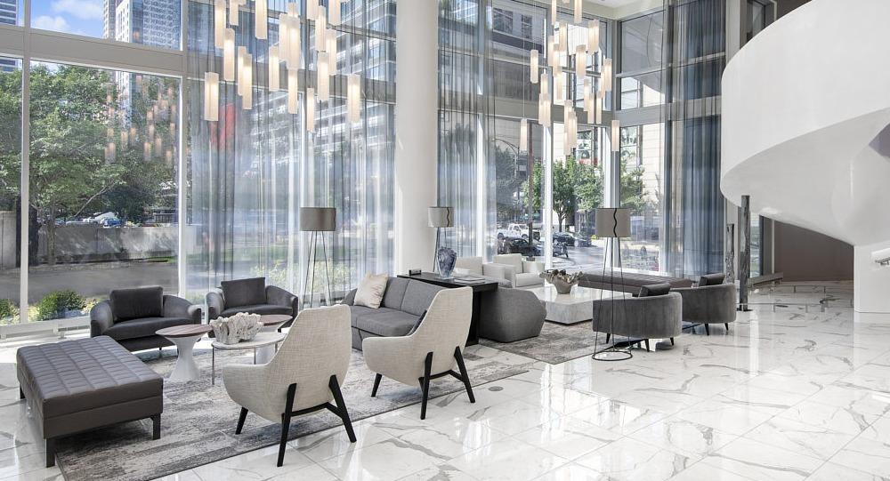Spacious lobby with marble floors, elegant seating, and dramatic chandeliers at 465 North Park apartments in Chicago