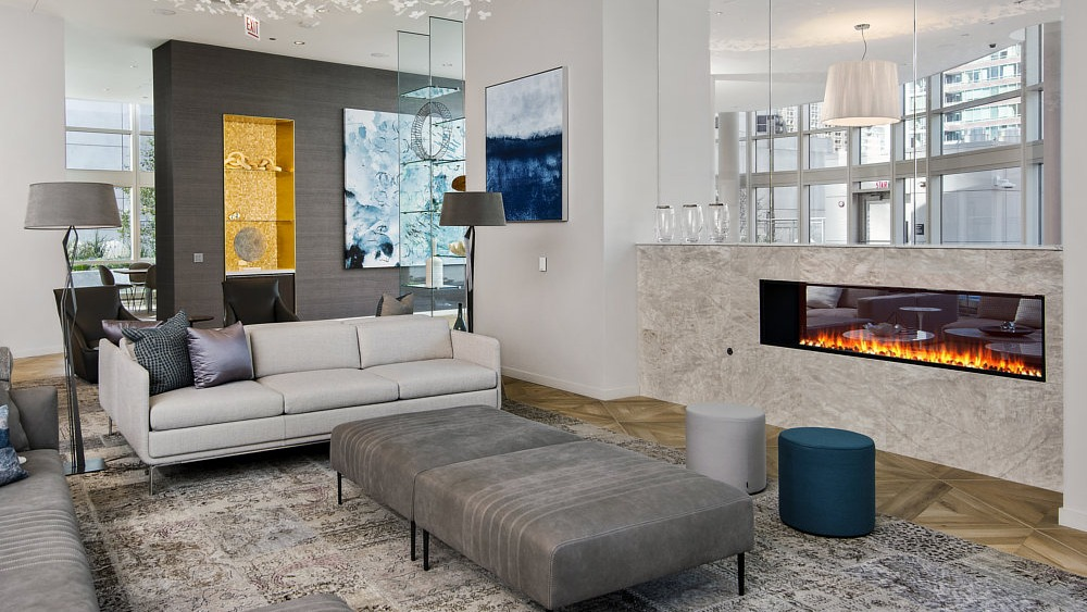 Resident lounge with modern fireplace, cozy seating, and artistic décor at 465 North Park apartments in Chicago