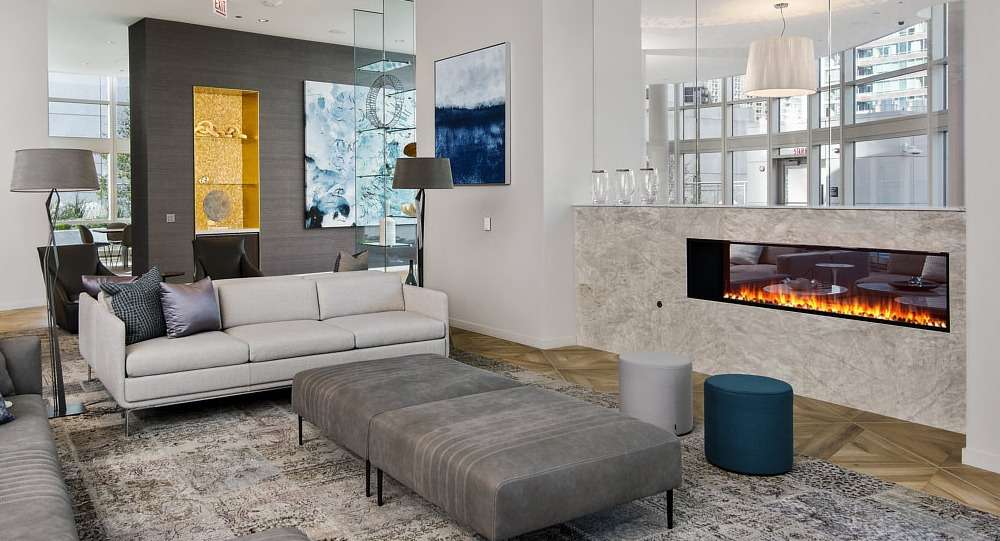 Resident lounge with modern fireplace, cozy seating, and artistic décor at 465 North Park apartments in Chicago