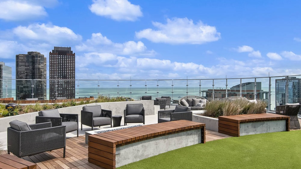 Rooftop terrace with modern seating, green space, and lake views at 465 North Park apartments in Chicago