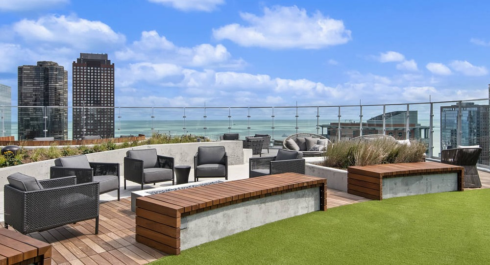 Rooftop terrace with modern seating, green space, and lake views at 465 North Park apartments in Chicago