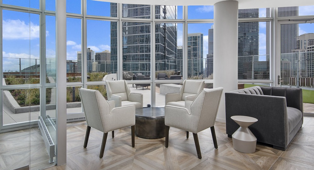 Sky lounge with panoramic views, modern seating, and floor-to-ceiling windows at 465 North Park apartments in Chicago