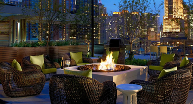 Rooftop firepit lounge with cozy seating and Chicago skyline views at 500 Lake Shore Drive apartments