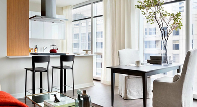 Stylish open kitchen with breakfast bar, dining area, and natural light at 500 Lake Shore Drive luxury apartments in Chicago