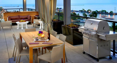 Outdoor dining area with grill, seating, and lakefront views at 500 Lake Shore Drive luxury apartments in Chicago