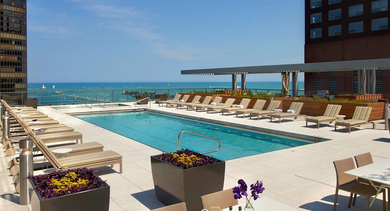 Outdoor swimming pool with lounge chairs and lakefront views at 500 Lake Shore Drive luxury apartments in Chicago