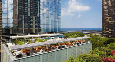 Rooftop terrace with landscaped greenery, lounge seating, and lake views at 500 Lake Shore Drive apartments in Chicago