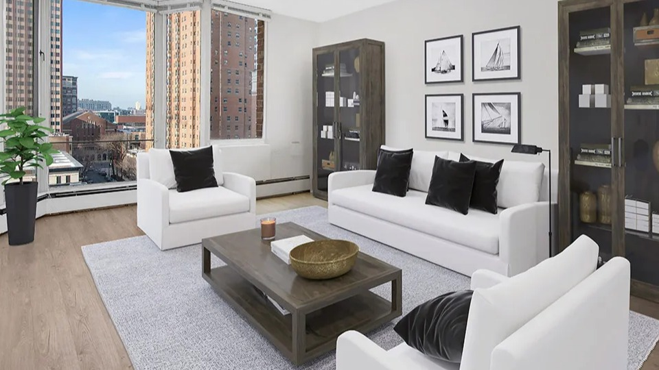 Spacious living room with large bay windows, white sofa set, gray rug, and display cabinets showcasing city views at 55 West Chestnut apartments in Chicago