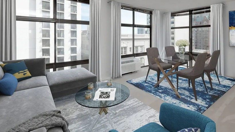 Corner living and dining area with floor-to-ceiling windows, modern furnishings, and city views at 65 East Scott apartments in Chicago