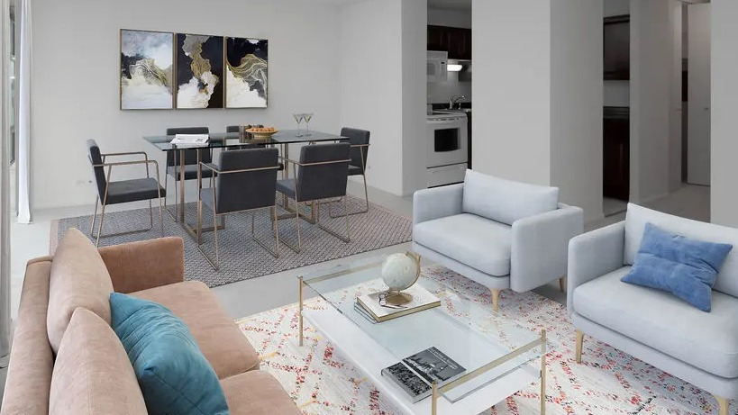 Spacious living room with large windows, seating area, glass coffee table, and a dining nook at 65 East Scott apartments in Chicago