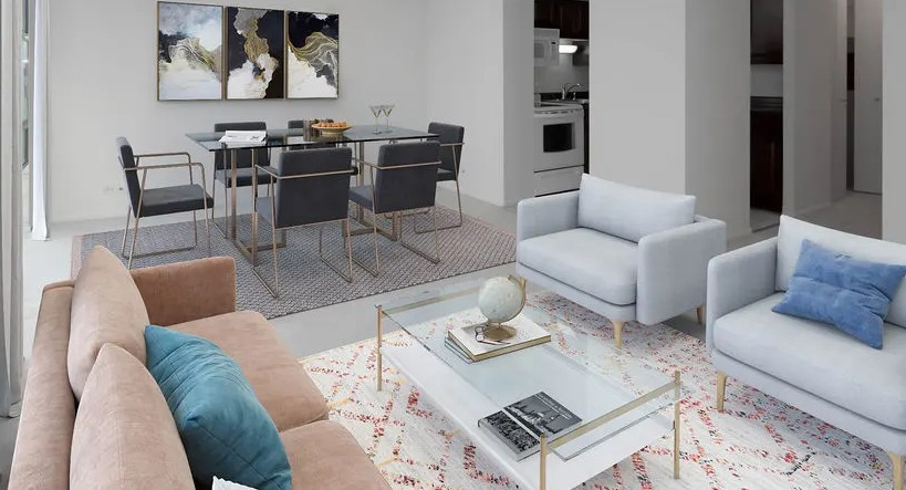 Spacious living room with large windows, seating area, glass coffee table, and a dining nook at 65 East Scott apartments in Chicago