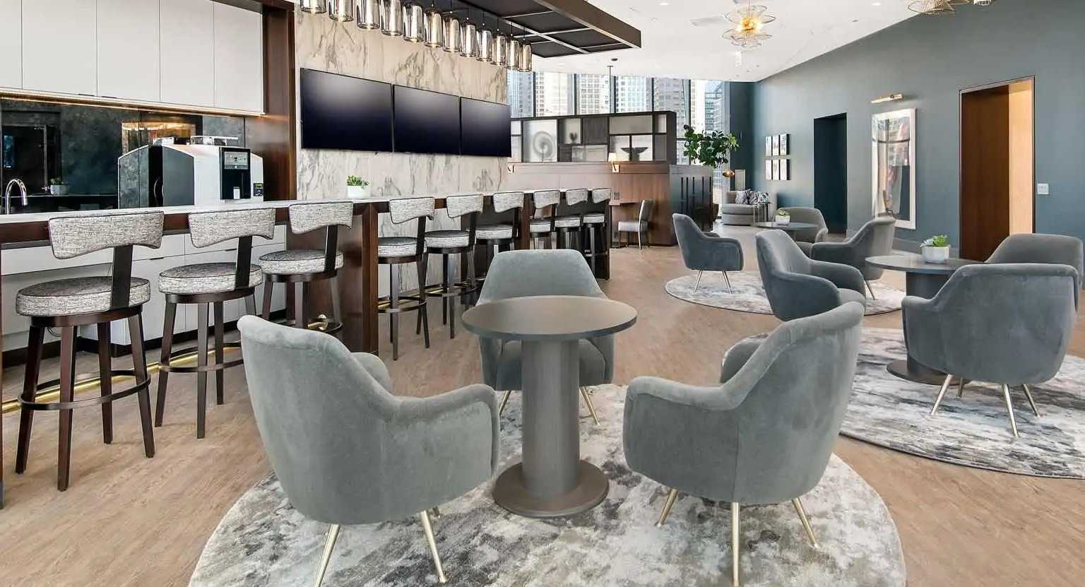 Chic coffee bar and social lounge at 727 West Madison, featuring marble accents, long bar seating, plush club chairs, and modern lighting in Chicago