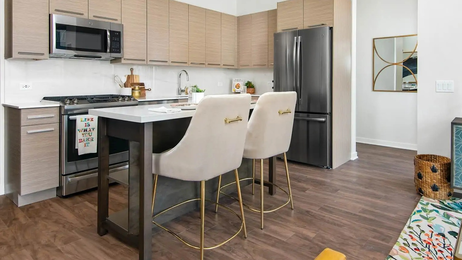 Modern kitchen at 727 West Madison in Chicago featuring flat-panel cabinets, island seating, stainless appliances, and a bright open layout