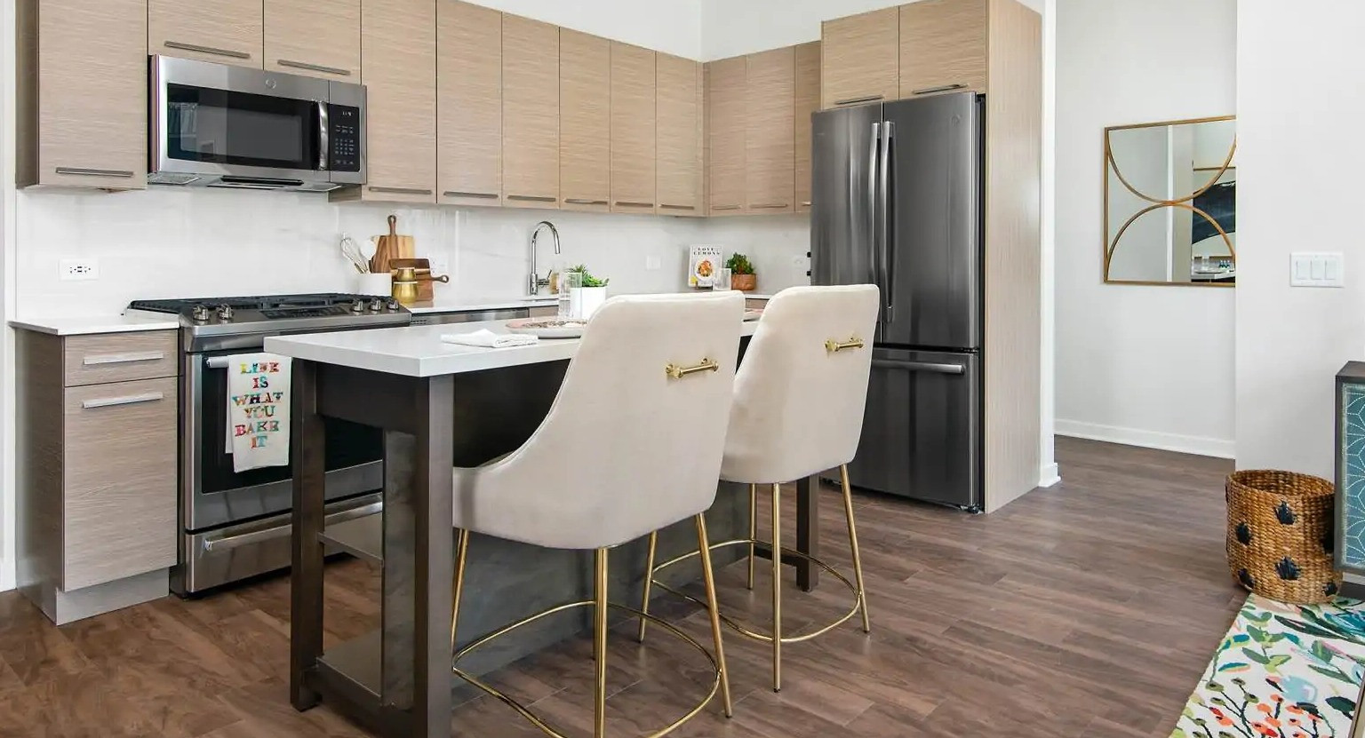 Modern kitchen at 727 West Madison in Chicago featuring flat-panel cabinets, island seating, stainless appliances, and a bright open layout