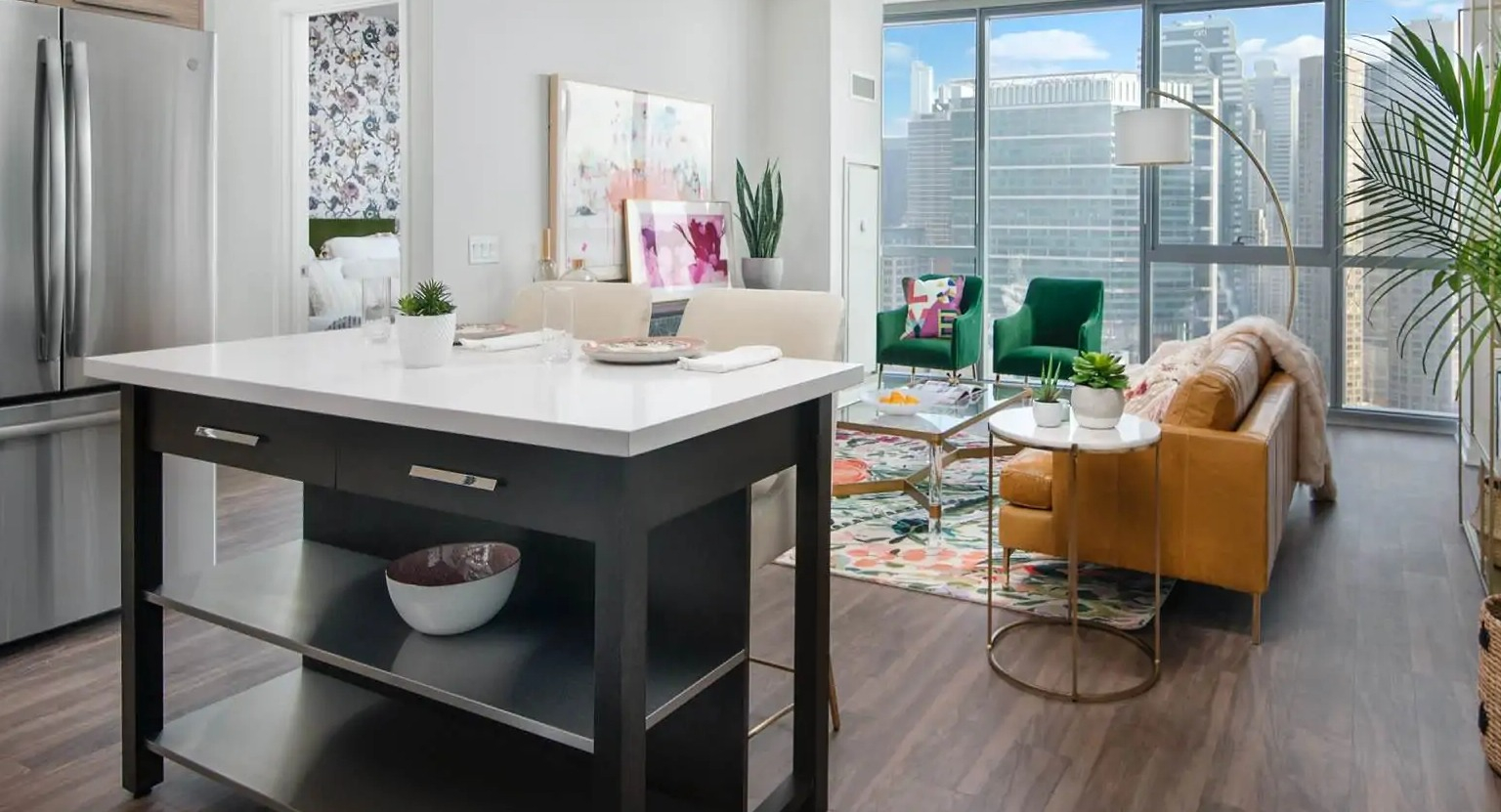 Open-concept living area at 727 West Madison in Chicago with island seating, chic décor, and expansive windows framing downtown views