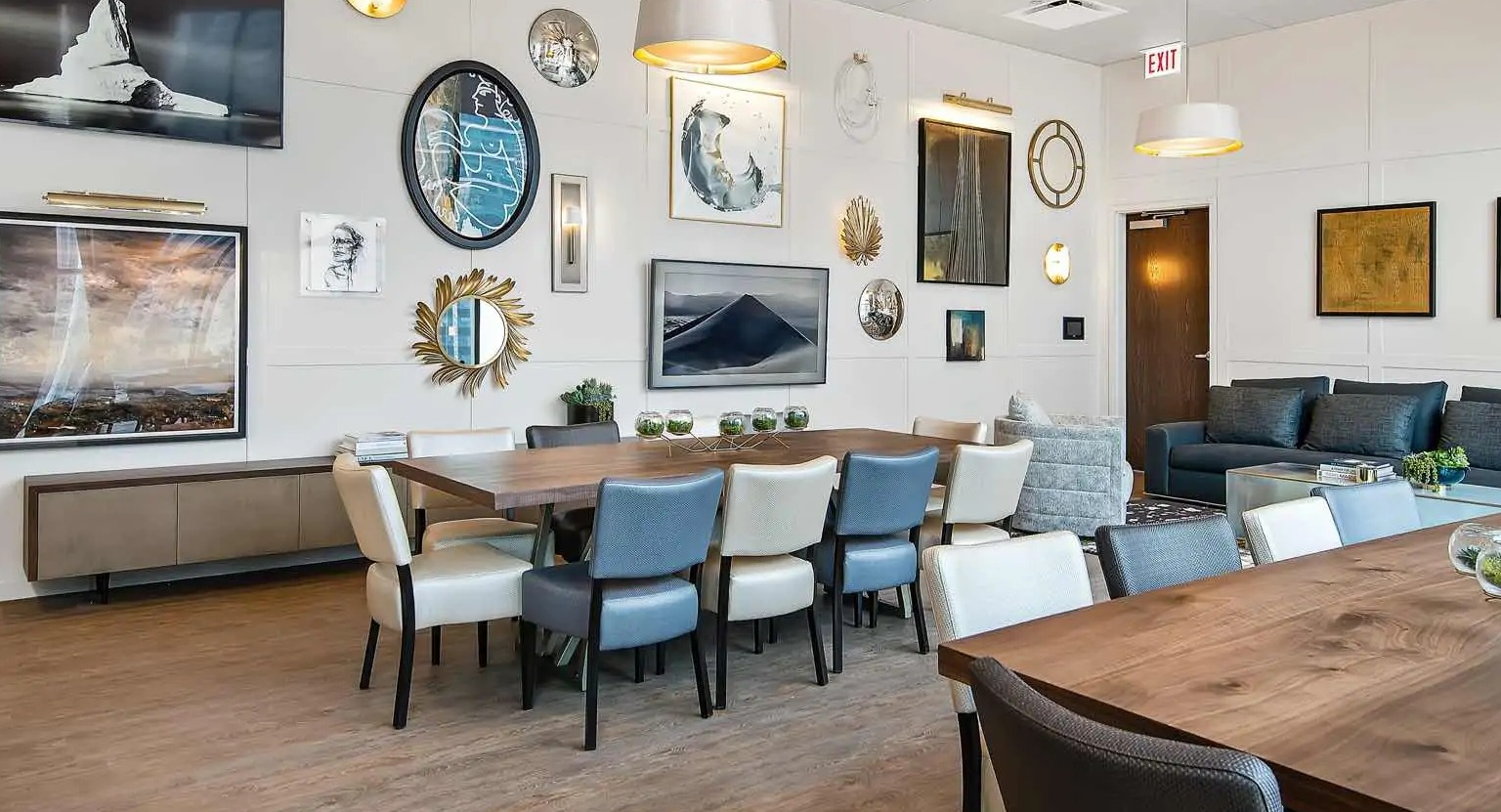 Elegant party room at 727 West Madison in Chicago, offering long dining tables, artwork-filled walls, and comfortable lounge seating for gatherings