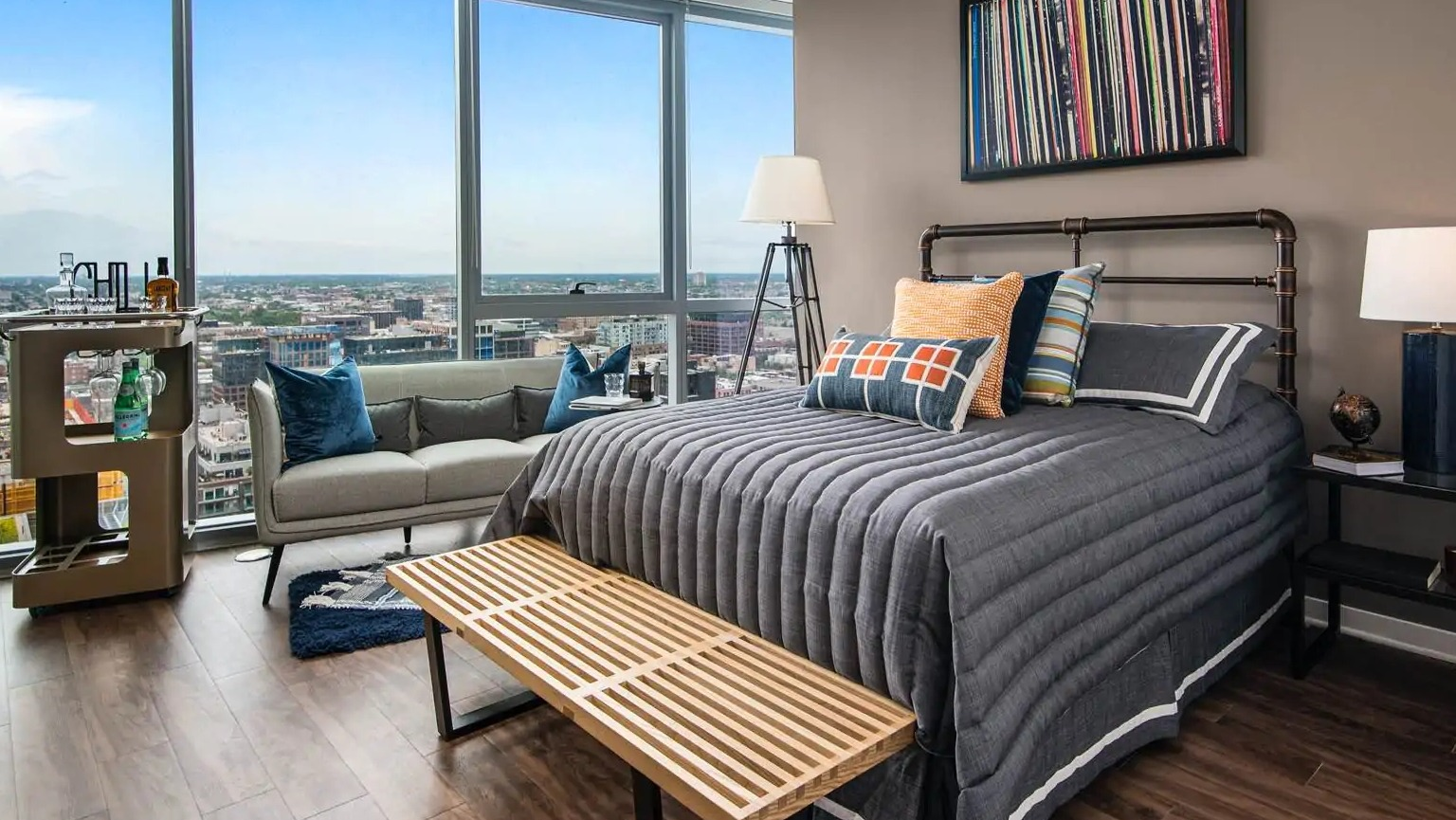 Penthouse corner living room at 727 West Madison in Chicago featuring wraparound glass, neutral furnishings, and wide skyline views