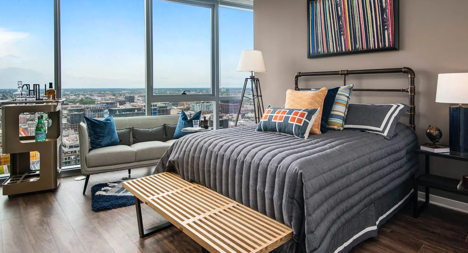 Penthouse corner living room at 727 West Madison in Chicago featuring wraparound glass, neutral furnishings, and wide skyline views