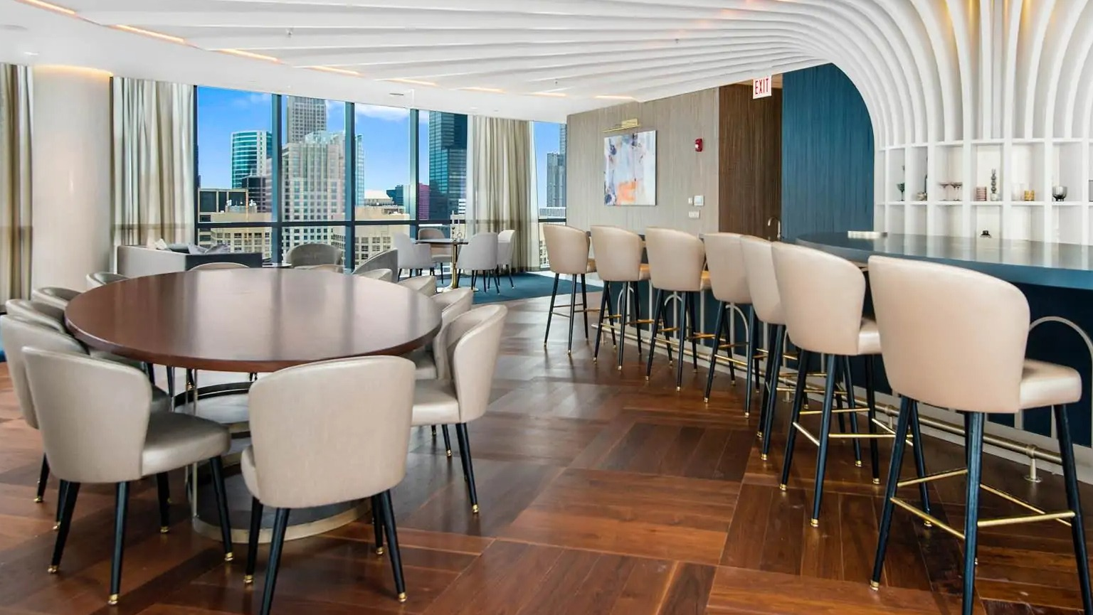 Penthouse sky lounge at 727 West Madison in Chicago with statement ceiling, bar seating, round tables, and city views for private events