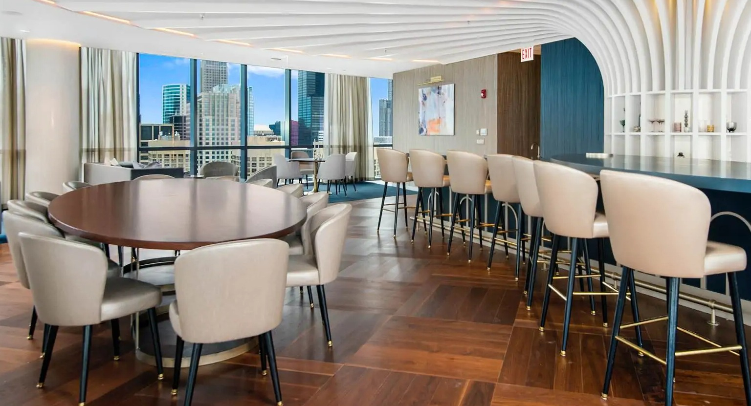 Penthouse sky lounge at 727 West Madison in Chicago with statement ceiling, bar seating, round tables, and city views for private events
