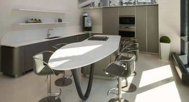 High-ceiling amenity kitchen with large island, sleek cabinetry, and a skyline mural at 73 East Lake apartments in Chicago