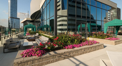 Rooftop terrace with skyline views, cabanas, and cushioned seating at 73 East Lake apartments in downtown Chicago