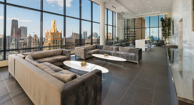 Sky lounge with modern sofas, cocktail tables, and panoramic skyline views at 73 East Lake apartments in downtown Chicago