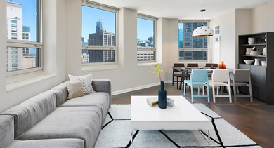 Modern living and dining room with corner windows and city views at 750 N Rush St apartments in River North, Chicago—open layout perfect for entertaining