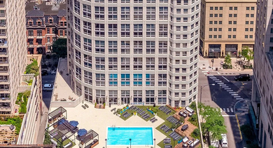 River North high-rise at 750 N Rush St in Chicago with rooftop-style pool deck, lounge seating, and skyline surroundings—premium apartment building near Michigan Ave