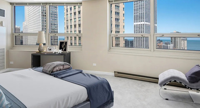 Spacious corner bedroom with wraparound windows and lake views at 750 N Rush St apartments in River North, Chicago—ideal for renters who love natural light