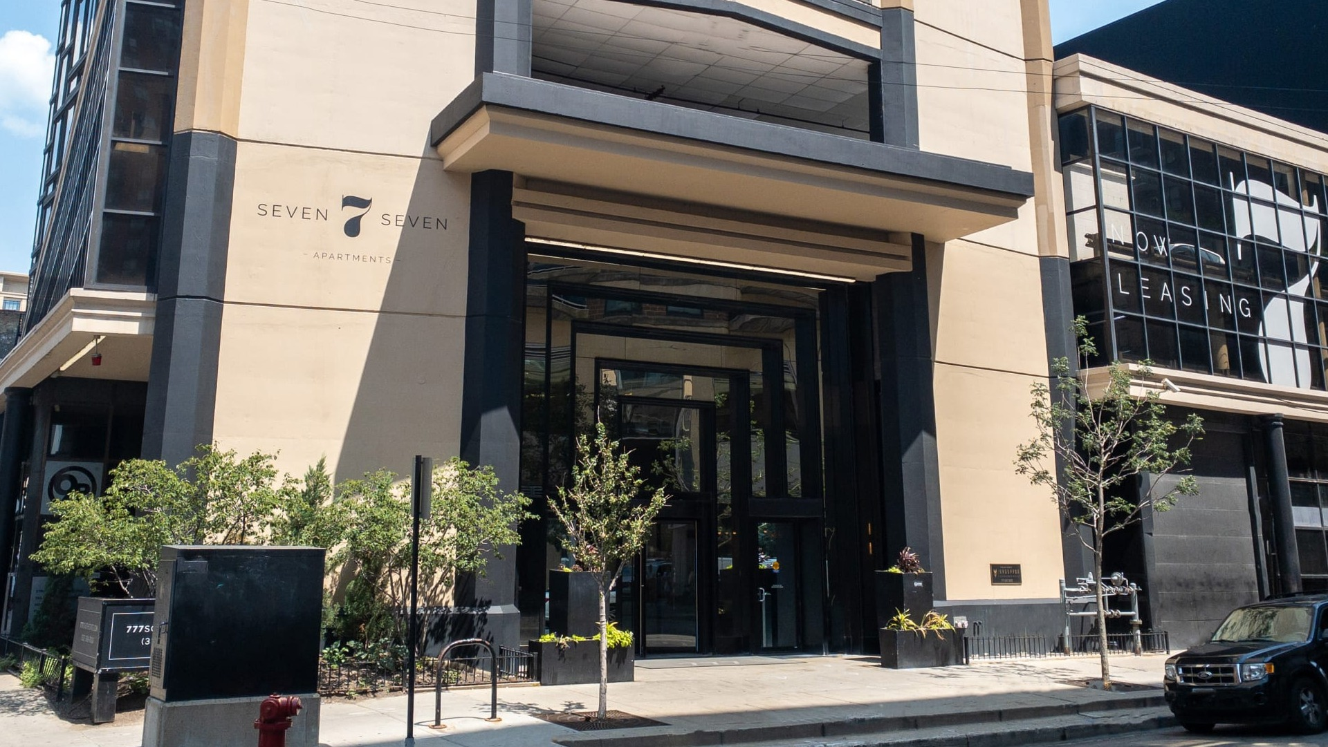 Exterior view of 777 South State apartments in Chicago, showing the entrance canopy, street frontage, and neighborhood setting