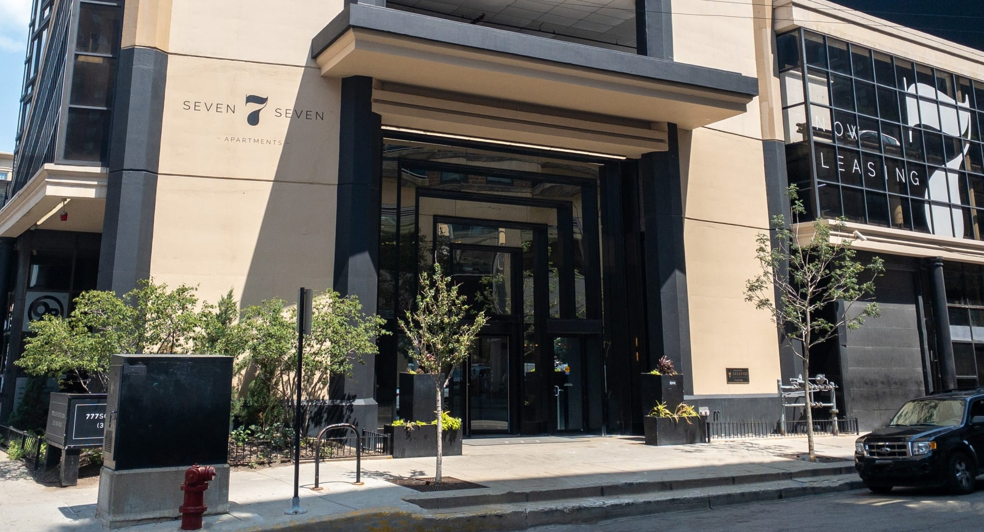 Exterior view of 777 South State apartments in Chicago, showing the entrance canopy, street frontage, and neighborhood setting