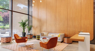 Inviting lobby lounge with floor-to-ceiling windows, pendant lighting, and mid-century seating at 820 Michigan apartments in Chicago