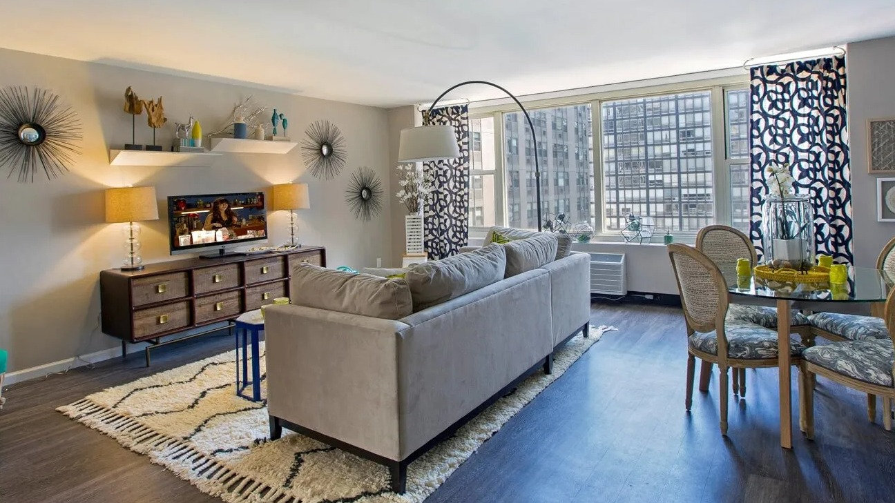 Spacious living and dining area with large windows, accent decor, and room to entertain at 860 N Dewitt Apartments in Chicago